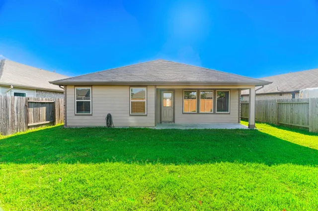 a view of a house with a backyard