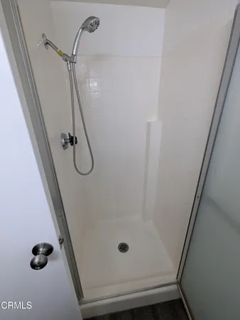 a bathroom with a glass door shower