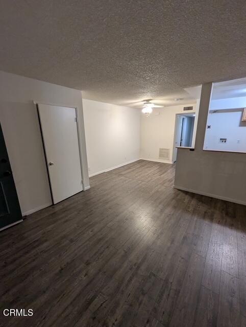 1851 Patricia Avenue, Unit 102 Simi Valley, CA 93065 - Photo 3 of 23 a view of an empty room with wooden floor and a window