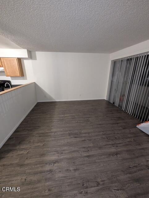 1851 Patricia Avenue, Unit 102 Simi Valley, CA 93065 - Photo 4 of 23 a view of an empty room with wooden floor and a window