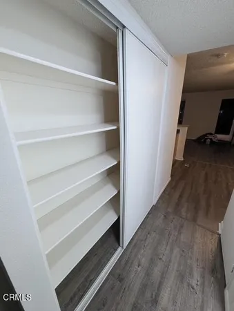 a view of walk in closet with empty racks