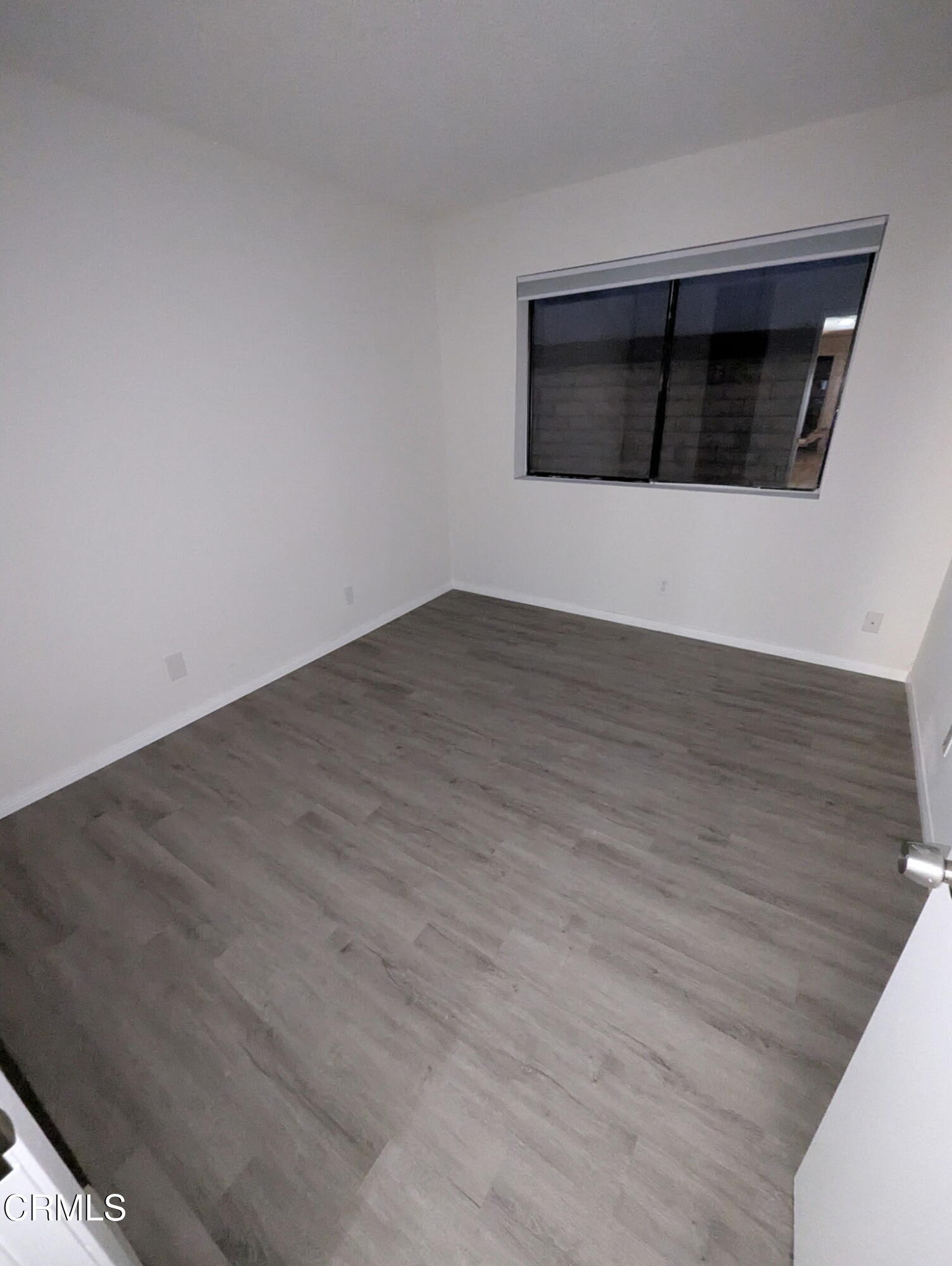 1851 Patricia Avenue, Unit 102 Simi Valley, CA 93065 - Photo 9 of 23 a view of an empty room with wooden floor and a fireplace