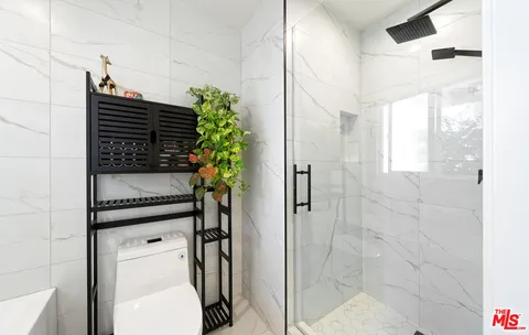 a bathroom with a toilet and a shower