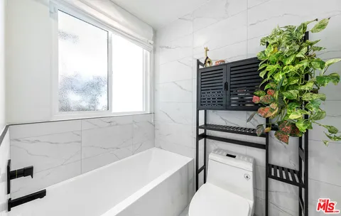 a bathroom with a bathtub a sink and a toilet