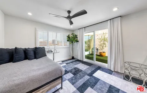 a large bedroom with a large bed and a large window