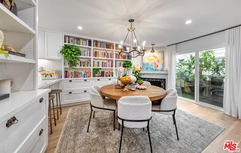 a view of a dining room with furniture wooden floor and chandelier