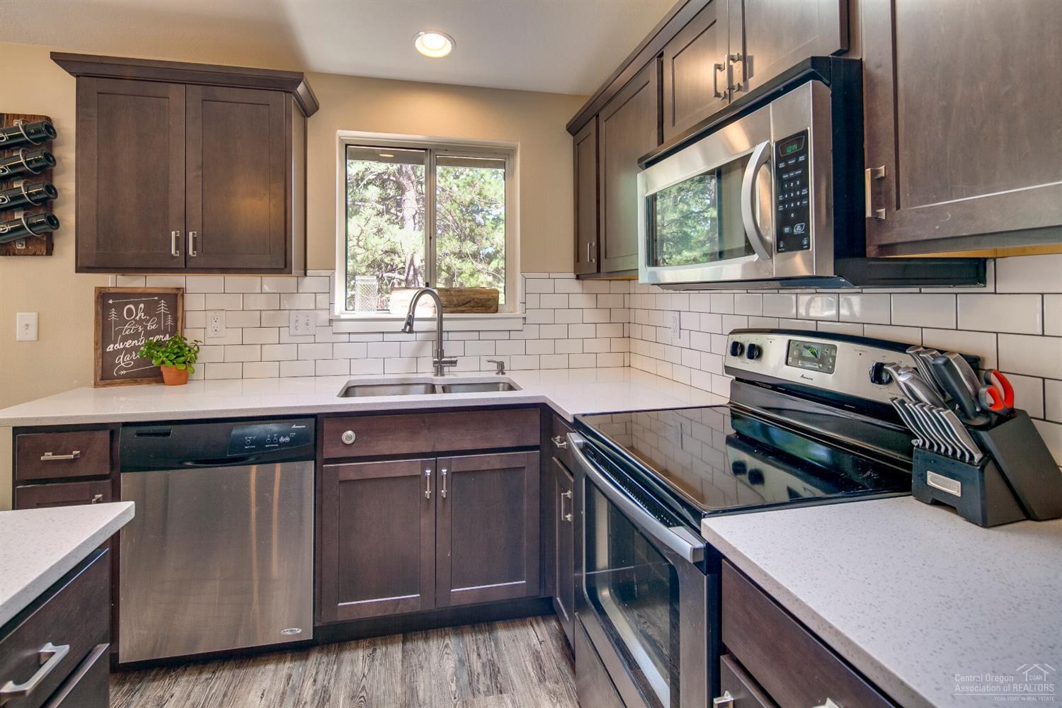 60175 Cheyenne Road Bend, OR 97702 - Photo 8 of 24 a kitchen that has a sink and a stove