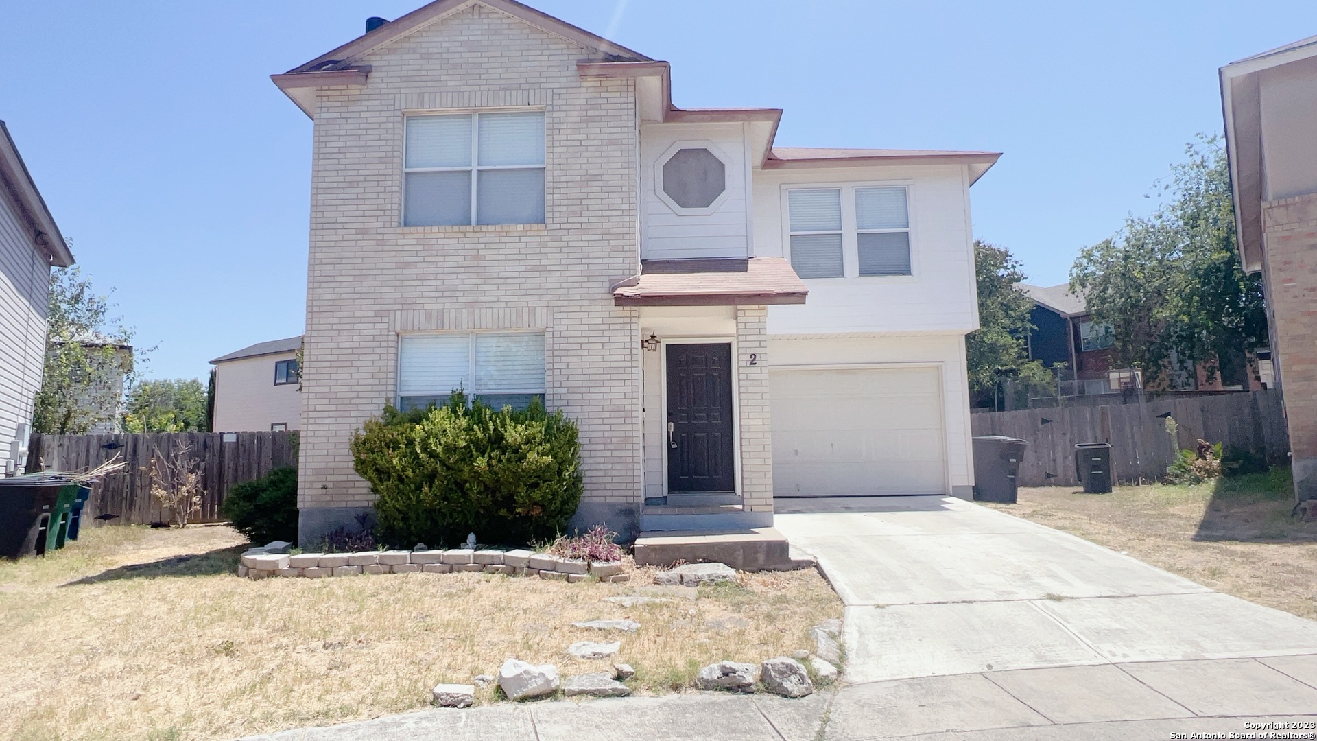 2 Torreys Post San Antonio, TX 78240 - Photo 1 of 1 a front view of a house with a yard and garage