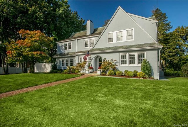 a front view of house with yard and green space