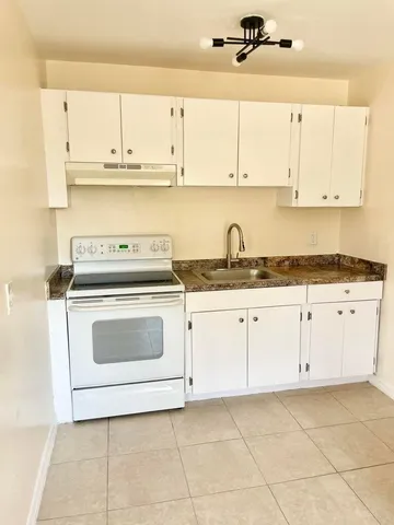 a kitchen with cabinets and white appliances