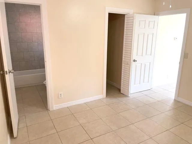 a view of an empty room and a fan
