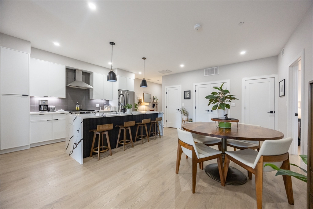 70 Shawsheen Road, Unit PH5 Boston, MA 02128 - Photo 11 of 42 a kitchen with a table and chairs in it