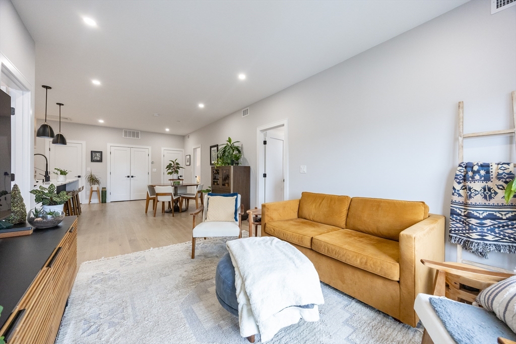70 Shawsheen Road, Unit PH5 Boston, MA 02128 - Photo 15 of 42 a living room with furniture and wooden floor