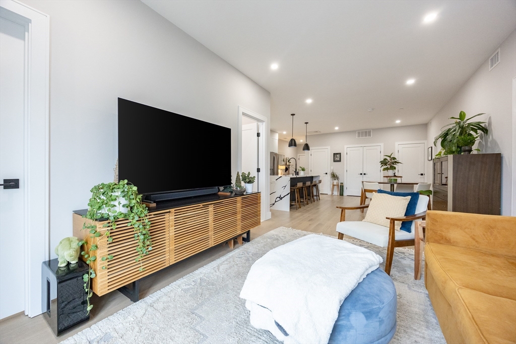 70 Shawsheen Road, Unit PH5 Boston, MA 02128 - Photo 17 of 42 a living room with furniture and a flat screen tv