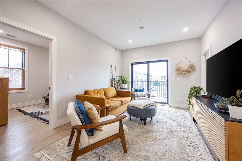 70 Shawsheen Road, Unit PH5 Boston, MA 02128 - Photo 18 of 42 a living room with furniture and a flat screen tv