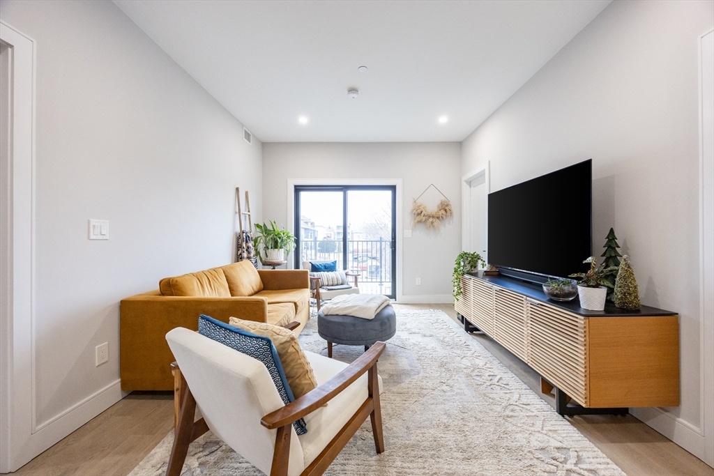 70 Shawsheen Road, Unit PH5 Boston, MA 02128 - Photo 19 of 42 a living room with furniture and a flat screen tv