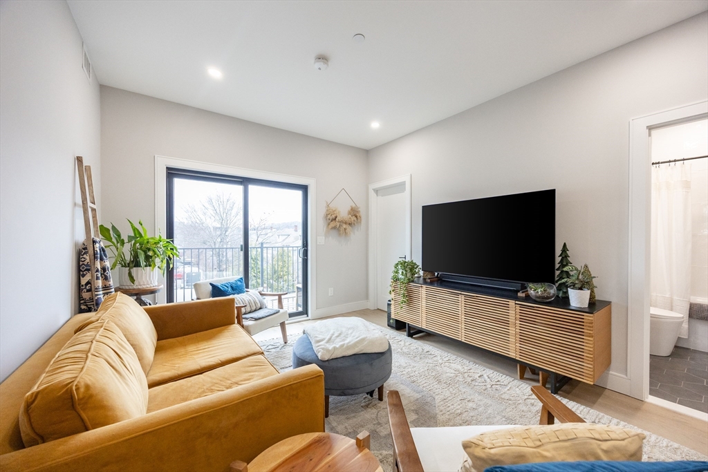 70 Shawsheen Road, Unit PH5 Boston, MA 02128 - Photo 20 of 42 a living room with furniture and a flat screen tv