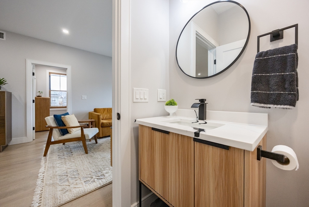 70 Shawsheen Road, Unit PH5 Boston, MA 02128 - Photo 22 of 42 a bathroom with a sink and a mirror