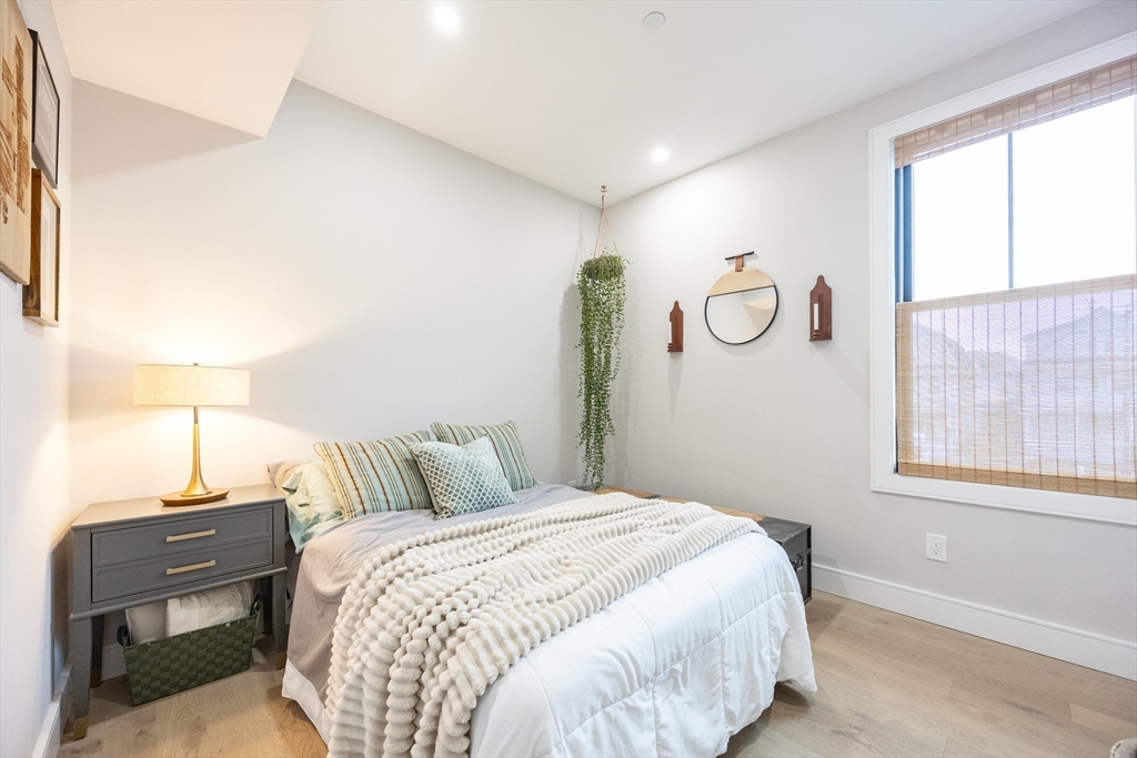 70 Shawsheen Road, Unit PH5 Boston, MA 02128 - Photo 24 of 42 a bedroom with a bed and wooden floor