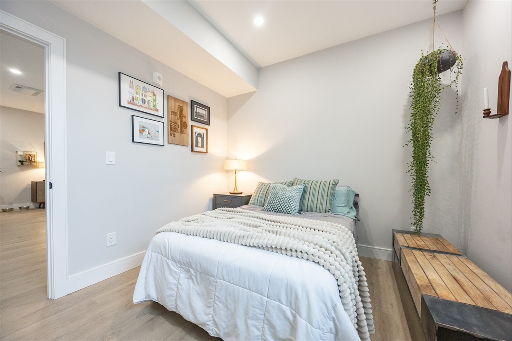 70 Shawsheen Road, Unit PH5 Boston, MA 02128 - Photo 25 of 42 a bedroom with a bed and a painting on the wall