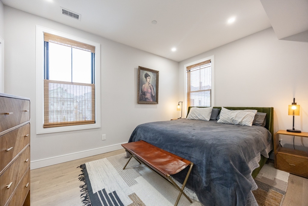 70 Shawsheen Road, Unit PH5 Boston, MA 02128 - Photo 26 of 42 a bedroom with a bed and wooden floor