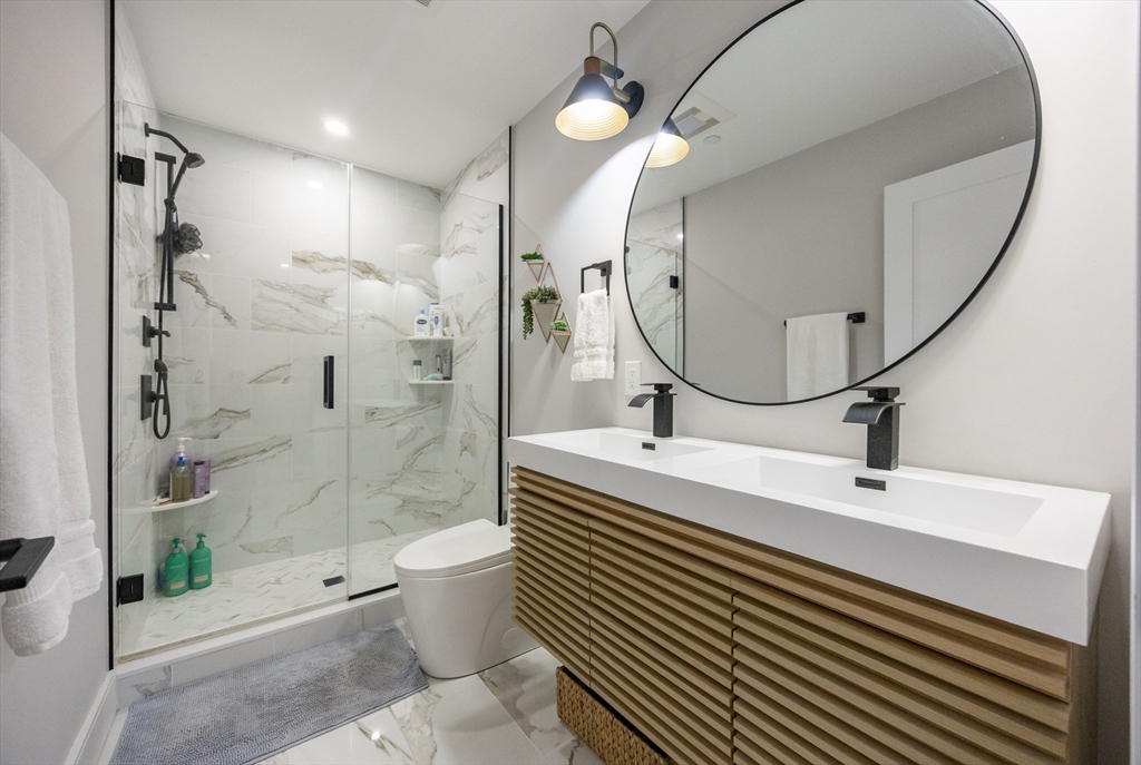 70 Shawsheen Road, Unit PH5 Boston, MA 02128 - Photo 33 of 42 a bathroom with a sink a toilet and shower
