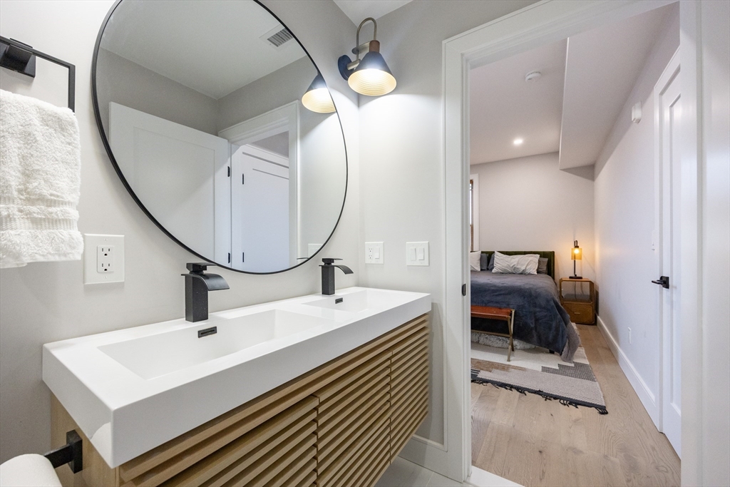 70 Shawsheen Road, Unit PH5 Boston, MA 02128 - Photo 34 of 42 a en suite bathroom with a sink and a mirror