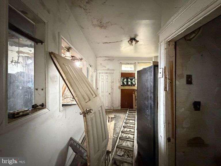 3923 Ridgewood Avenue Baltimore, MD 21215 - Photo 15 of 18 a view of a hallway with wooden floor and staircase