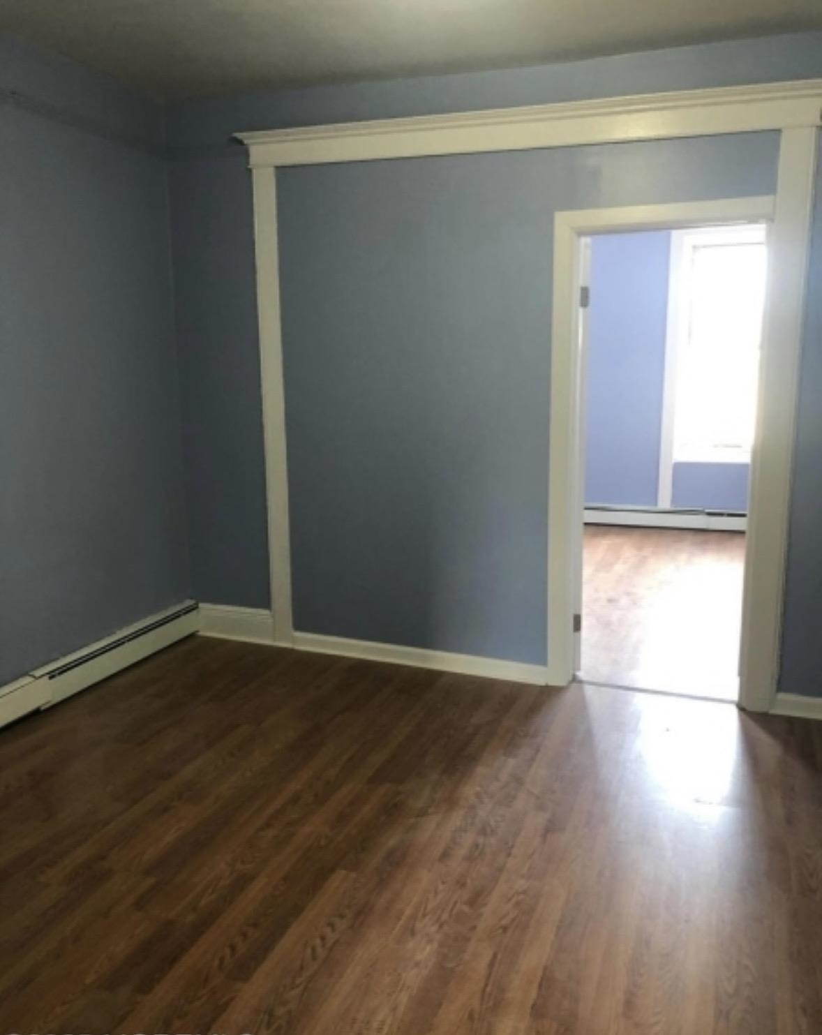 505 5th Street Union City, NJ 07087 - Photo 11 of 17 a view of an empty room with wooden floor and a window