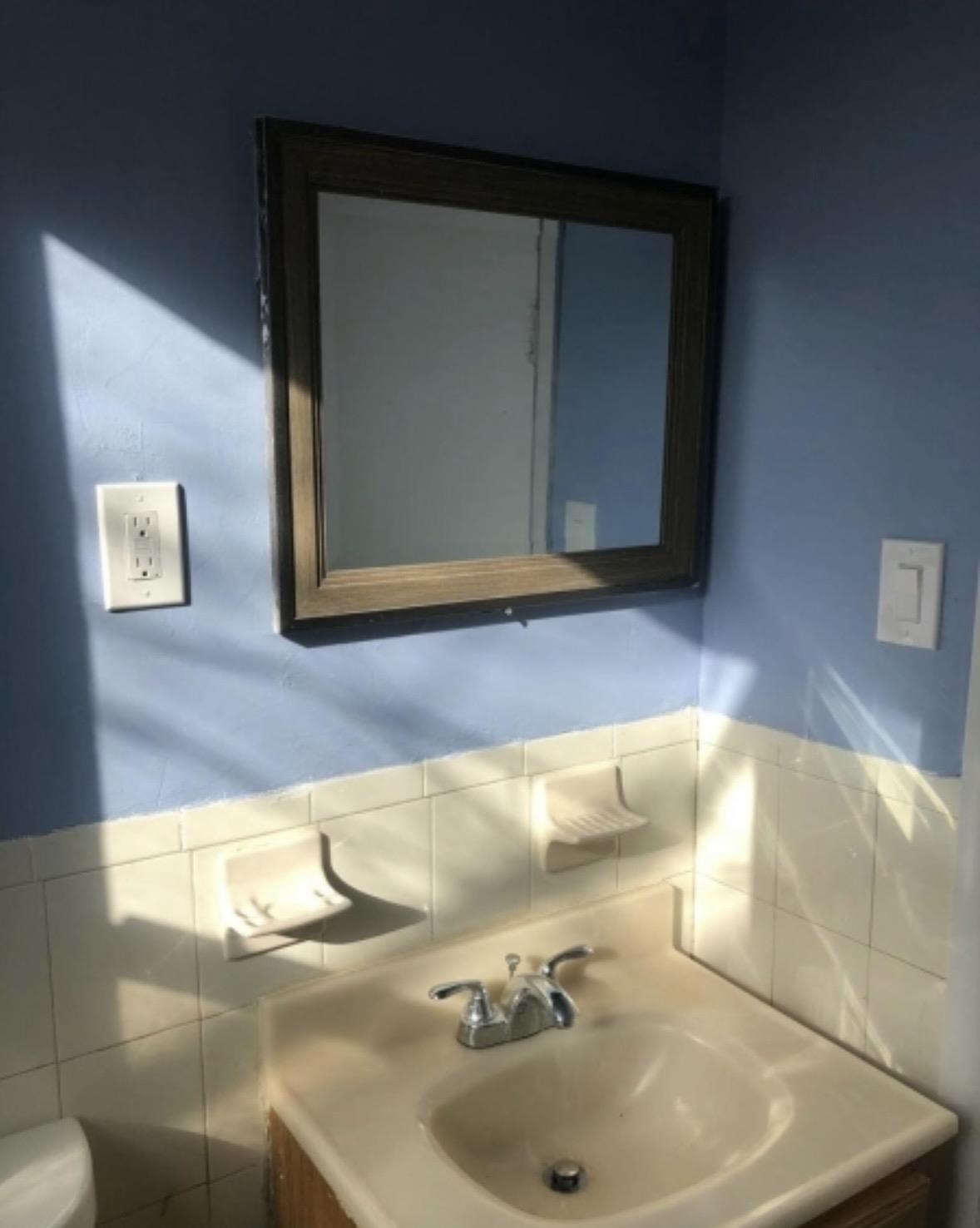 505 5th Street Union City, NJ 07087 - Photo 7 of 17 a bathroom with a sink and a mirror