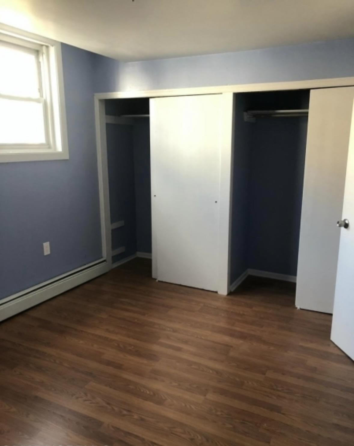 505 5th Street Union City, NJ 07087 - Photo 10 of 17 an empty room with wooden floor and windows