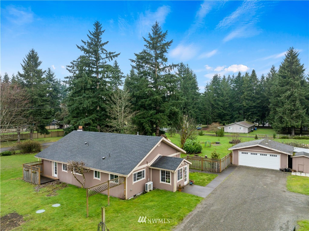 7232 191st Avenue Southwest Rochester, WA 98579 - Photo 1 of 40 a aerial view of a house with swimming pool and trees in the background