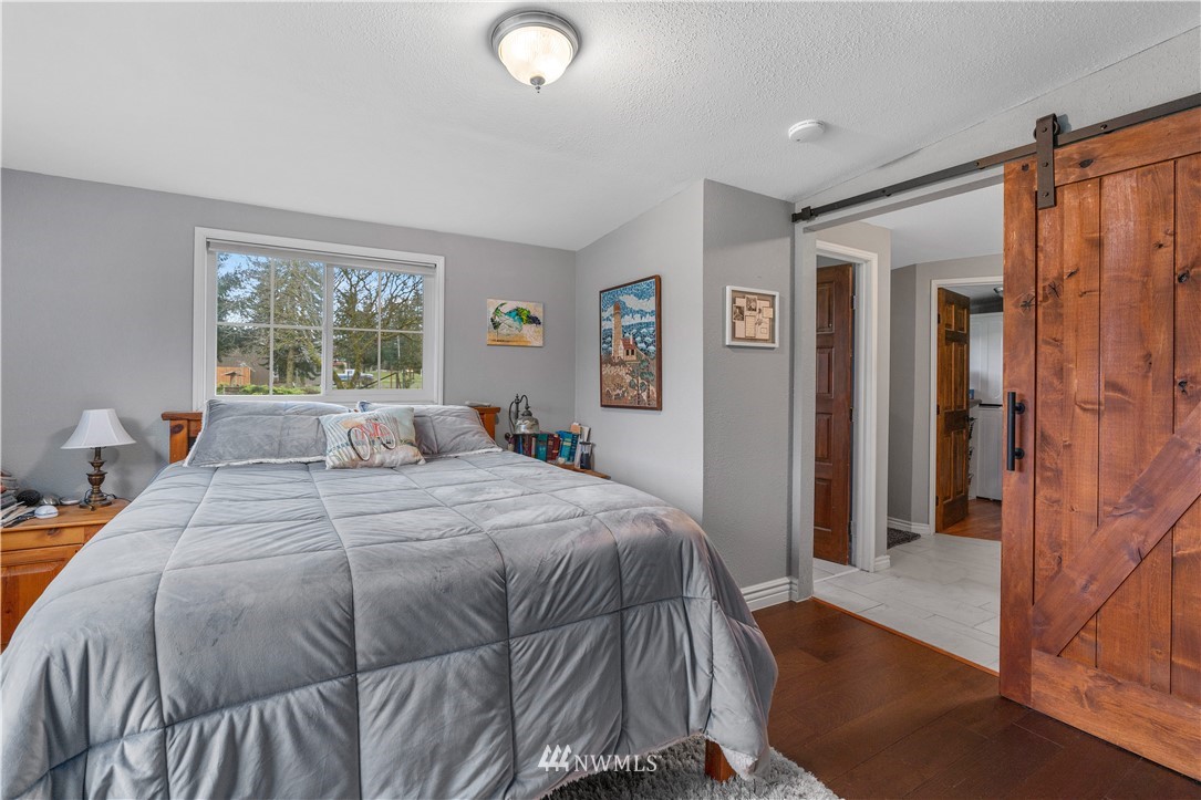 7232 191st Avenue Southwest Rochester, WA 98579 - Photo 21 of 40 a bedroom with a large bed and a closet