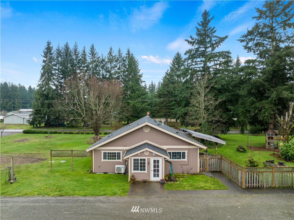 7232 191st Avenue Southwest Rochester, WA 98579 - Photo 3 of 40 a front view of a house with a garden