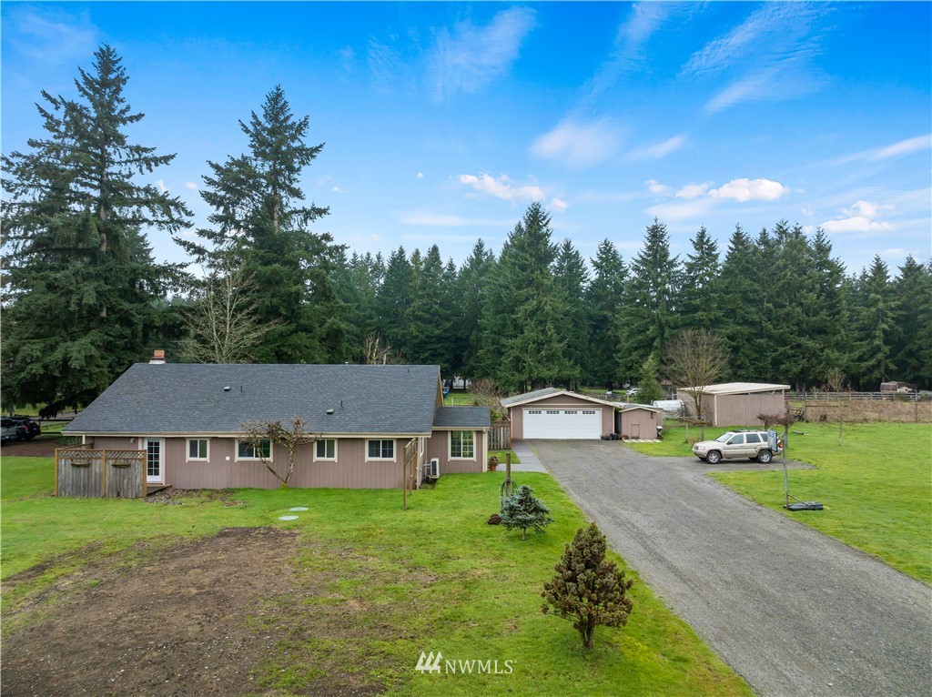 7232 191st Avenue Southwest Rochester, WA 98579 - Photo 5 of 40 a view of a house with backyard sitting area and garden