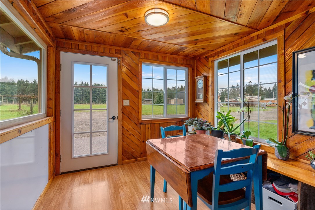 7232 191st Avenue Southwest Rochester, WA 98579 - Photo 10 of 40 a dining room with wooden floor and windows