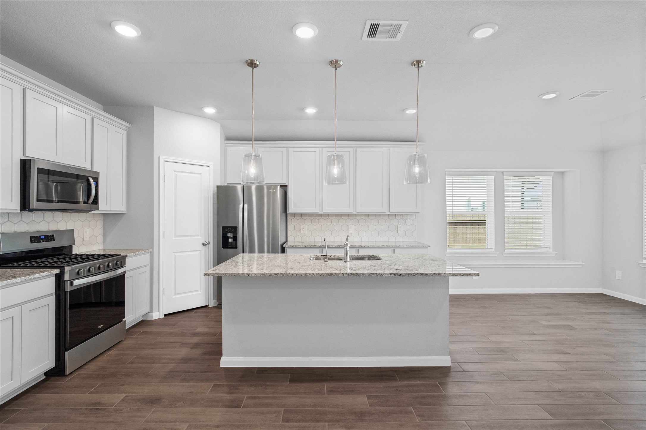 19645 Montgomery Rdg Way Montgomery, TX 77316 - Photo 21 of 41 The spacious kitchen and dining combination keeps everyone connected while offering a large center island, abundant cabinetry, and a bright breakfast nook for seamless everyday living and entertaining.