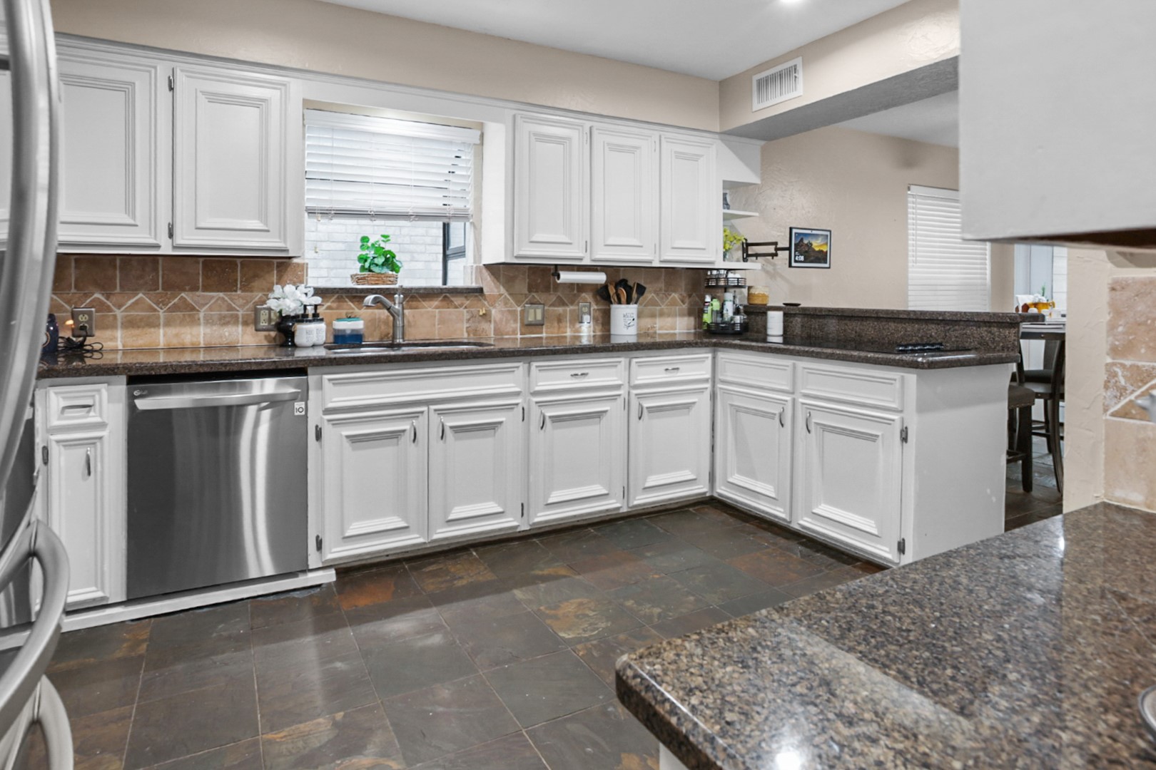 4505 Country Club View Baytown, TX 77521 - Photo 17 of 42 a kitchen with cabinets appliances a sink and a window