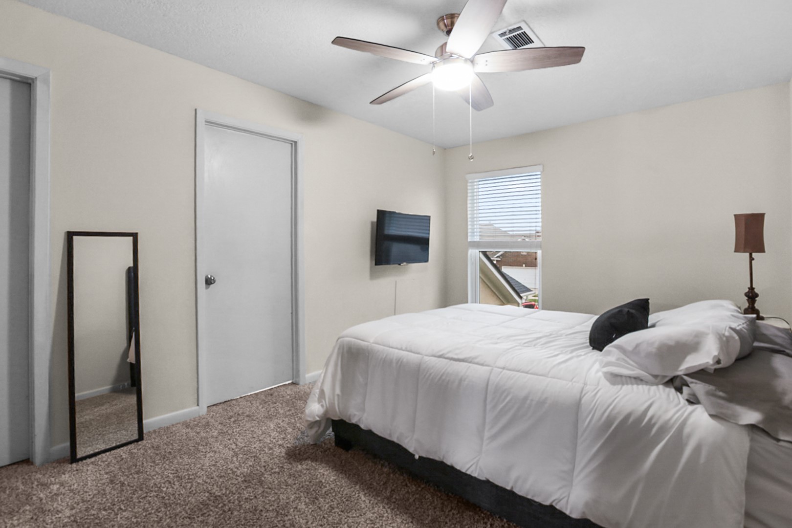 4505 Country Club View Baytown, TX 77521 - Photo 34 of 42 a bedroom with a large bed and a chandelier