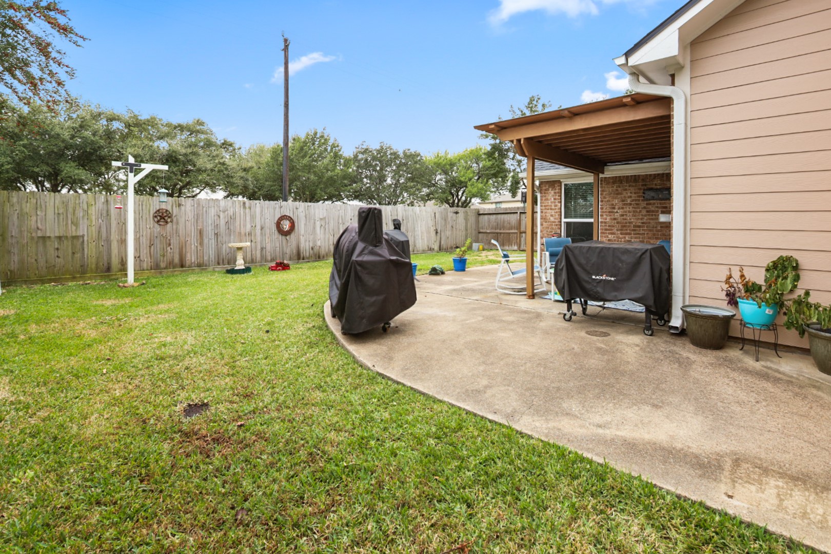 4505 Country Club View Baytown, TX 77521 - Photo 42 of 42 a view of a backyard with plants and a patio