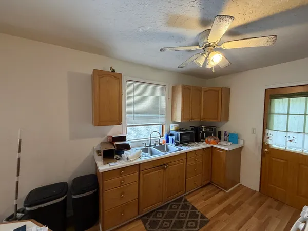 a kitchen with a sink appliances and cabinets