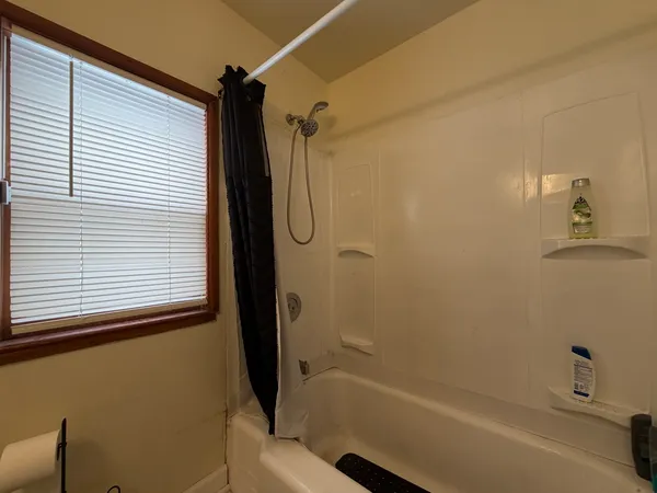 a bathroom with a shower and a bath tub