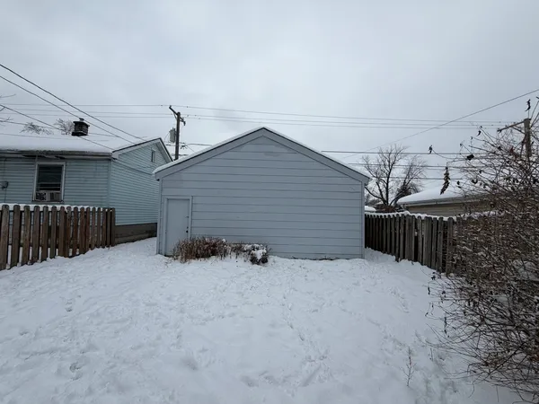 a view of a house with wooden fence