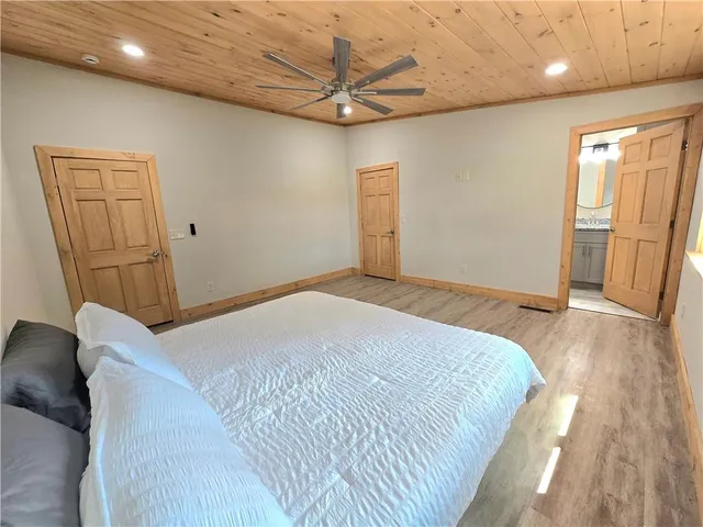 a bedroom with a bed and a ceiling fan