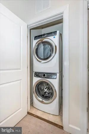 an empty room with closet and windows