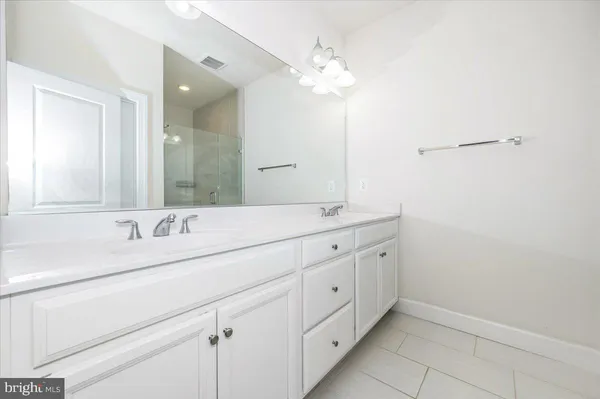 a bedroom with a large bed and a potted plant