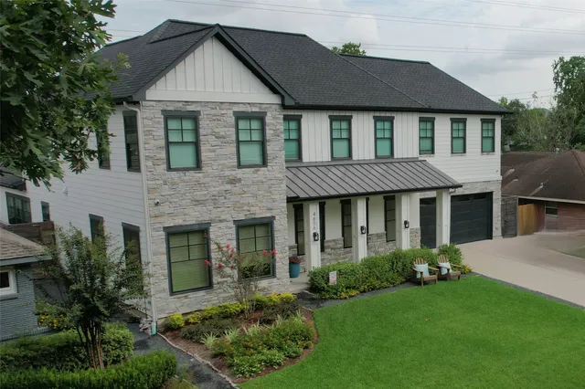 a front view of a house with a yard and porch