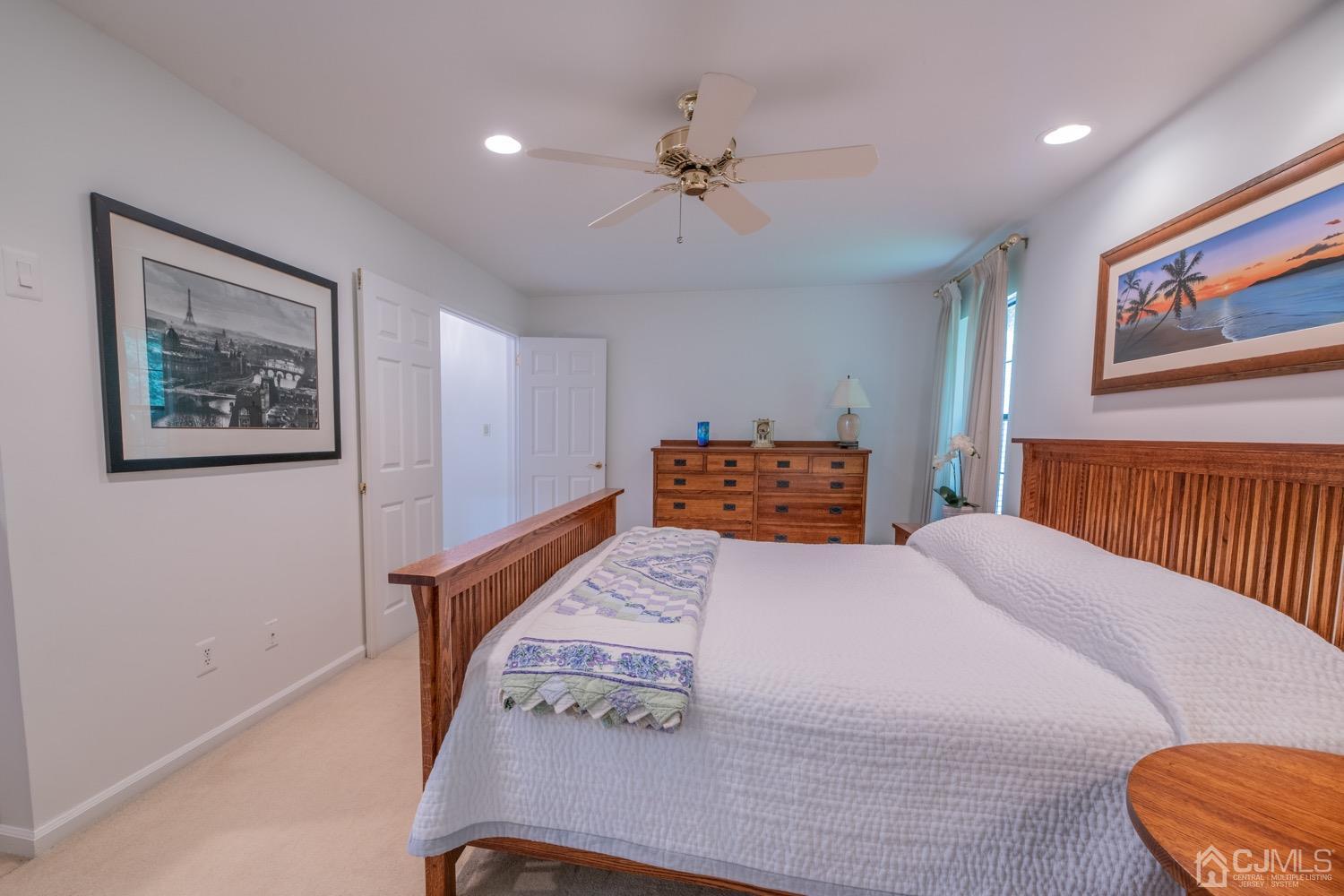 1306 Timber Oaks Road Edison, NJ 08820 - Photo 24 of 47 a bedroom with a large bed and a chandelier