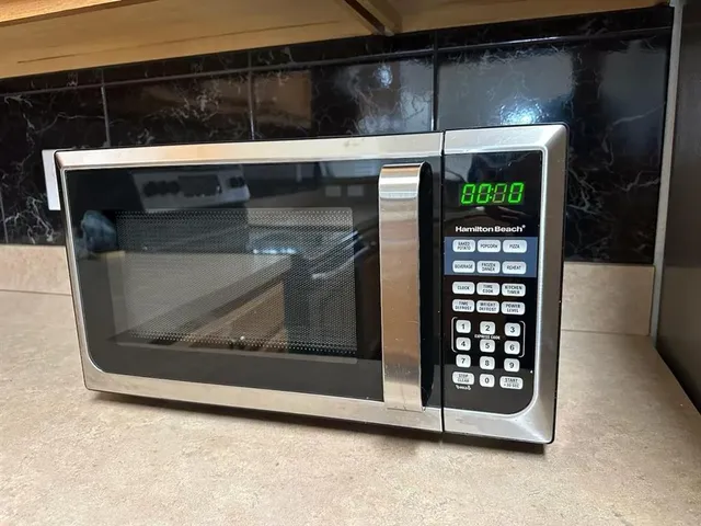 a stove top oven sitting inside of a kitchen