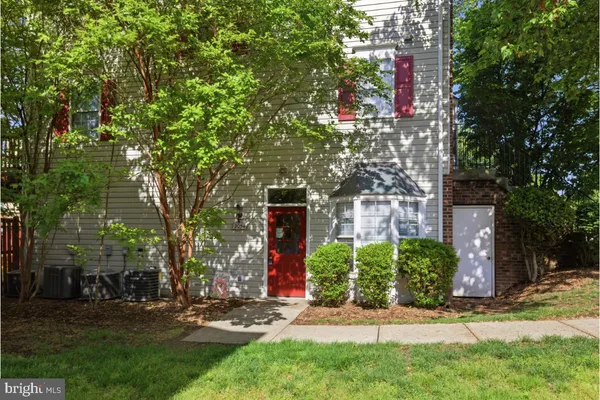 a view of a house with a tree in front of it